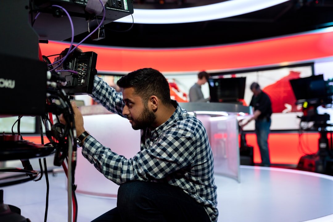 Television presenter speaking on a news studio set