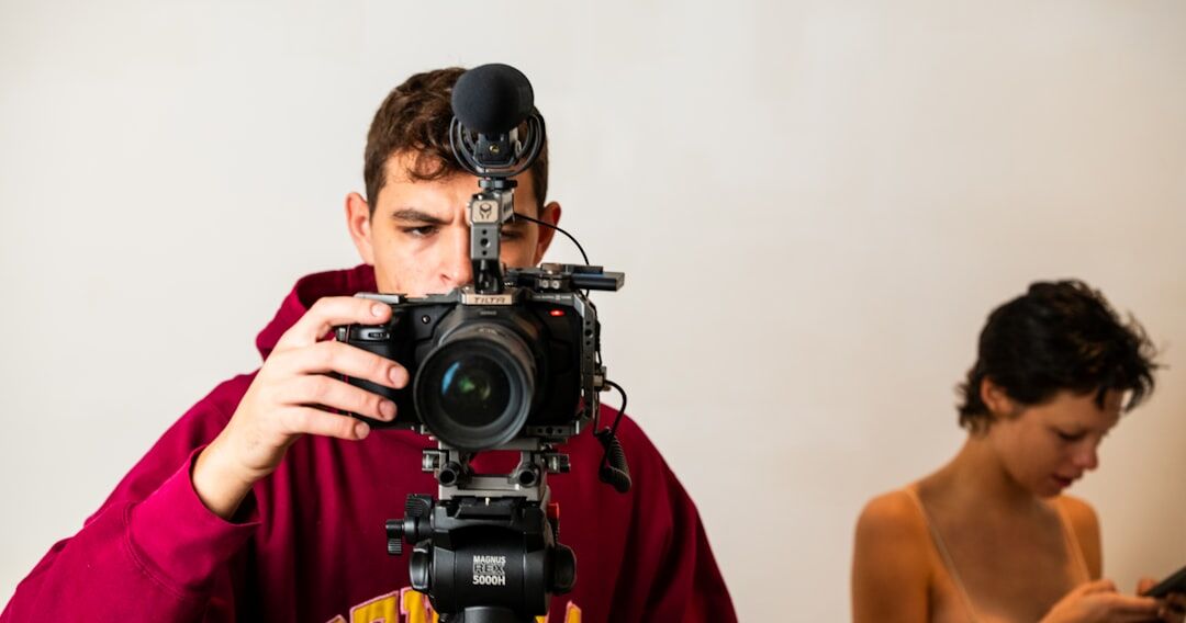 Professional video camera mounted on a tripod in a studio